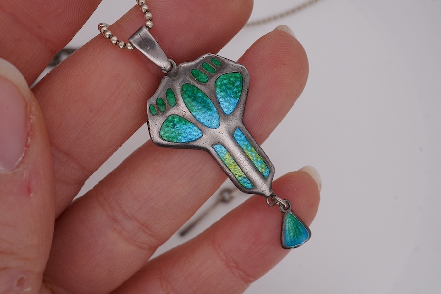 An Edwardian Art Nouveau silver and enamel drop pendant, by Charles Horner, Chester, 1908, 46mm, on a later 925 chain, together with one other Art Nouveau white metal, enamelled and mother of pearl set pendant necklace a